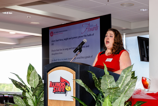 woman singing at podium