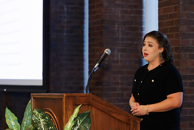 woman singing at podium