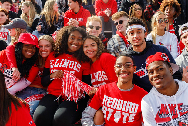 students posing at football game in ISU gear