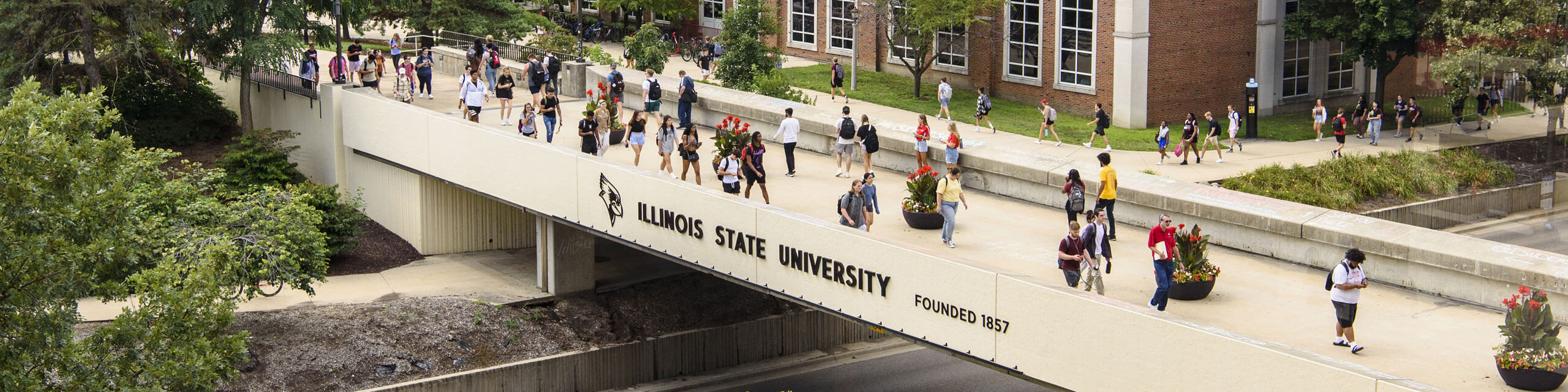 Students walk across the bridge on campus.