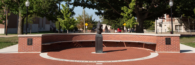 A bust of Reggie Redbird sits in the middle of a circular brick plaza.