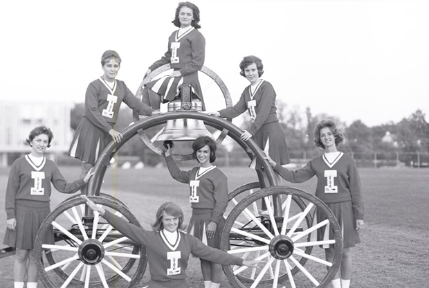 cheerleaders on the victory bell